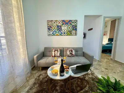 a living room with a couch and a table at Beautiful Dimora Anna e Ciccio in Casteldaccia