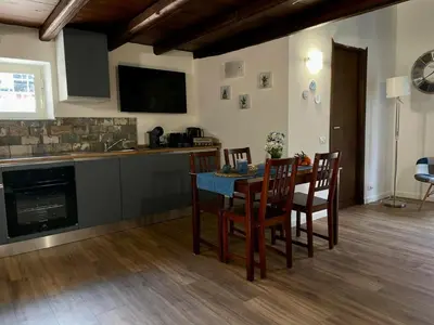 a kitchen and dining room with a table and chairs at Casa di Reginaldo al Capo in Palermo