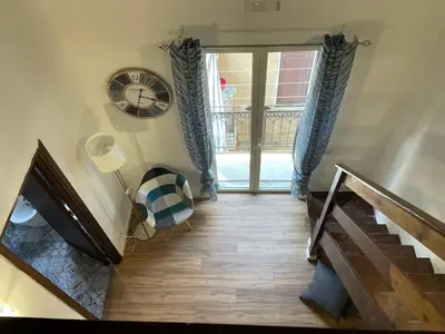 a room with a staircase and a clock on the wall at Casa di Reginaldo al Capo in Palermo