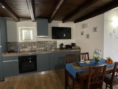 a kitchen with a table with a blue table cloth on it at Casa di Reginaldo al Capo in Palermo