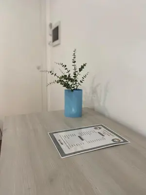 a potted plant in a blue vase on a table at Sicilia Bedda Room's in Palermo