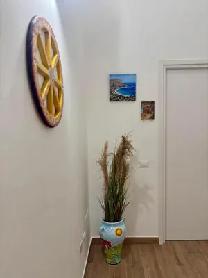 a room with a plant in a vase on a wall at Sicilia Bedda Room's in Palermo