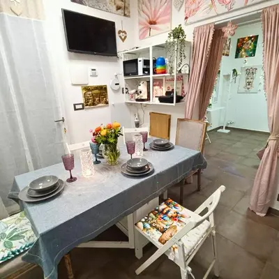 a dining room with a blue table and chairs at Casa Emilia in Palermo