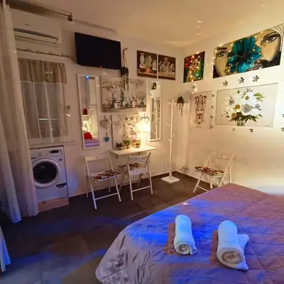 a bedroom with a bed and a table and chairs at Casa Emilia in Palermo