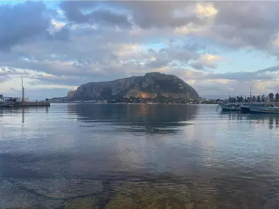 a mountain in the middle of a body of water at A Casa da Mammi in Palermo