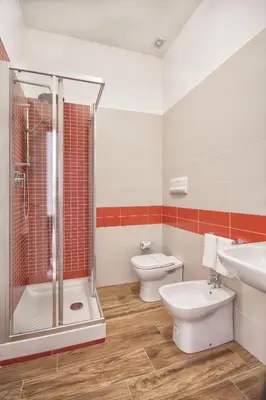 a bathroom with two toilets and a shower and a sink at B&B La Torre in Castellammare del Golfo