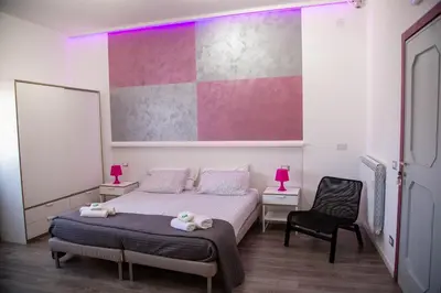 a bedroom with a bed with two stuffed animals on it at B&B Del Centro e SPA in Partinico