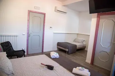 a room with a bed and a couch and a chair at B&B Del Centro e SPA in Partinico