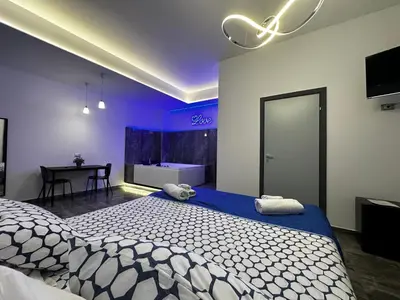 a bedroom with a bed and a table with a television at B&B Del Centro e SPA in Partinico