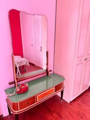 a mirror sitting on top of a dresser in a room at Via Zara Arararooms in Palermo