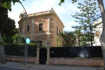 an old building with a gate in front of it at Villa 7 Palms Mondello Palermo Sicily in Palermo