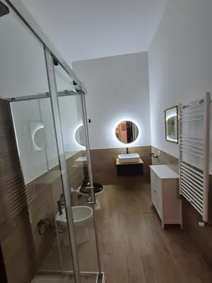 a bathroom with a glass shower and a sink at Casa Vacanza Mondello nel Cuore in Mondello
