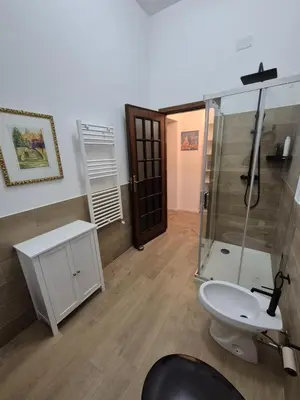 a bathroom with a shower and a toilet and a sink at Casa Vacanza Mondello nel Cuore in Mondello