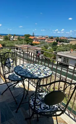 a patio with a table and chairs on a balcony at La Casetta di Gloria in Carini