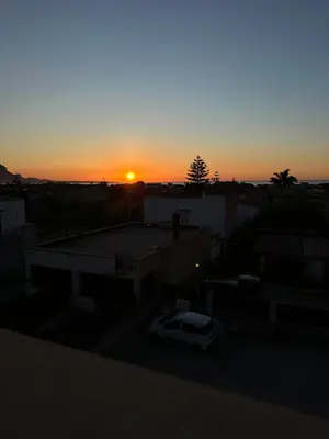 a sunset over a parking lot with a car at La Casetta di Gloria in Carini