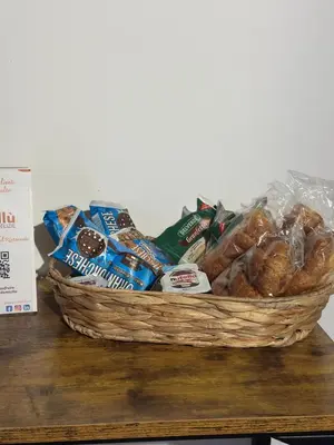 a basket of bread and other snacks on a table at La Casetta di Gloria in Carini