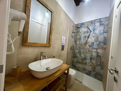 a bathroom with a sink and a shower at Massimo Rooms and suite in Palermo