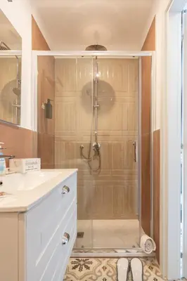 a bathroom with a shower with a glass door at Le Volte Del Basile - 4 camere private e terrazza in Palermo