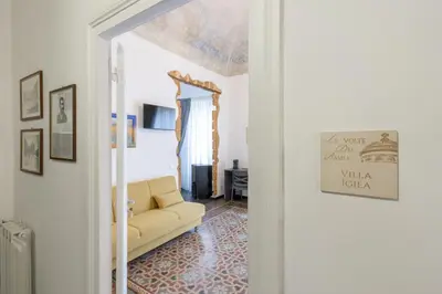 a living room with a yellow couch in a room at Le Volte Del Basile - 4 camere private e terrazza in Palermo