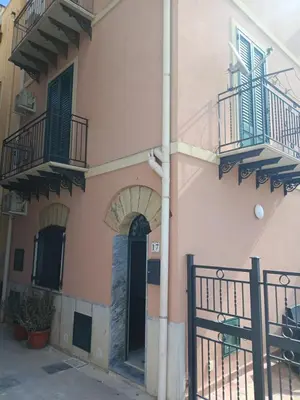 a pink building with balconies and a door at Case Nereidi 1 in Porticello
