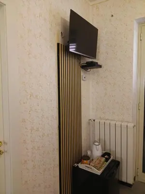 a corner of a room with a television on a wall at Case Nereidi 1 in Porticello