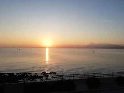 a sunset over a body of water with the sun setting at Case Nereidi 2 in Porticello