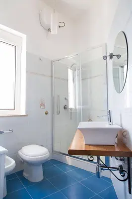 a bathroom with a tub and a toilet and a sink at Case Nereidi 2 in Porticello