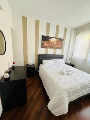 a bedroom with a large white bed and a desk at Michi House Appartamento in centro a Palermo in Palermo