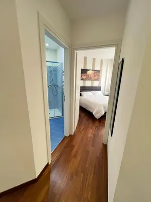 a bedroom with a bed and a bathroom with a shower at Michi House Appartamento in centro a Palermo in Palermo