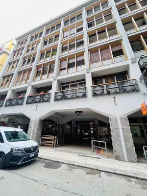 a white car parked in front of a building at Michi House Appartamento in centro a Palermo in Palermo