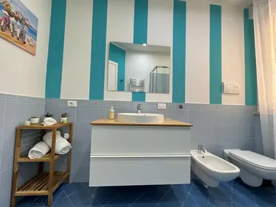 a bathroom with a sink and a toilet and a mirror at Michi House Appartamento in centro a Palermo in Palermo