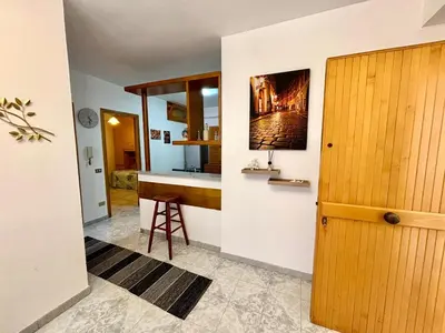 a kitchen with a counter and a stool in a room at Nelly's house in Terrasini