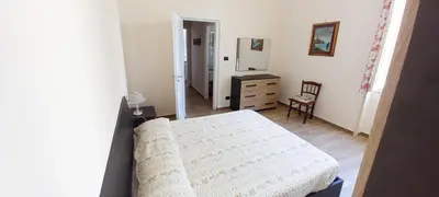 a bedroom with a bed and a dresser and a mirror at Casa Aurora G in Palermo
