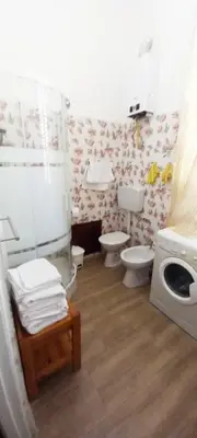 a bathroom with two toilets and a shower at Casa Aurora G in Palermo
