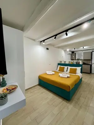 a bedroom with a bed and a kitchen at La dolce casa in Palermo