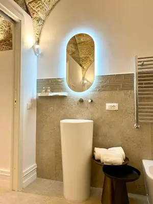 a bathroom with a sink and a mirror at Addimura rooms in Palermo