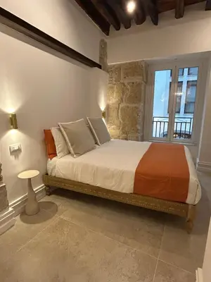 a bedroom with a large bed with a window at Addimura rooms in Palermo