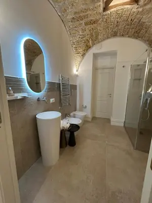 a bathroom with two sinks and a mirror at Addimura rooms in Palermo