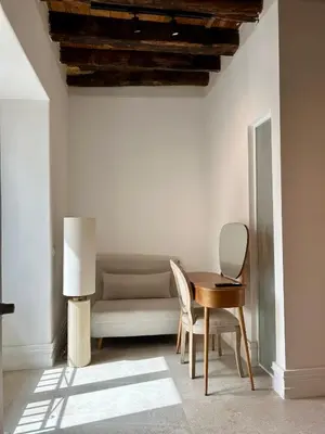 a table and chair in a room with a couch at Addimura rooms in Palermo