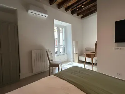 a bedroom with a bed and a chair and a desk at Addimura rooms in Palermo