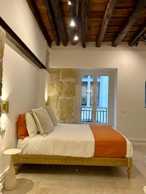 a bedroom with a bed in a room with a window at Addimura rooms in Palermo
