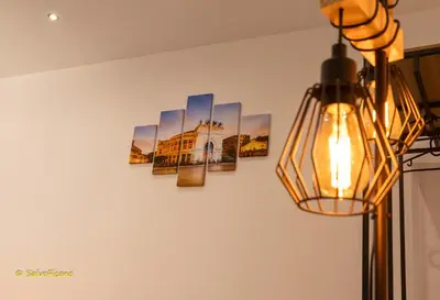 a wall with three pictures on it at GAle Apartment in Palermo