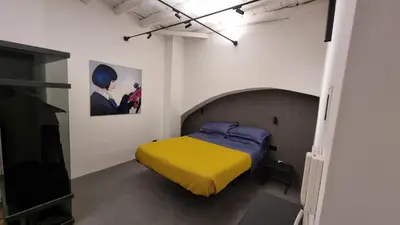 a bedroom with a bed with a yellow blanket at Suitt Drims 8 in Palermo