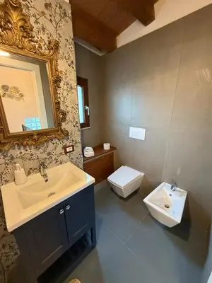 a bathroom with a sink and a toilet at Cortile Cipriani in Palermo