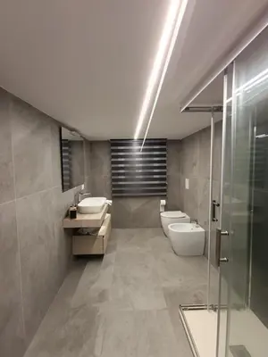 a bathroom with two toilets and two sinks and a shower at Home Luxury Felice Marine in Palermo