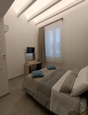 a bedroom with a large bed and a window at Home Luxury Felice Marine in Palermo