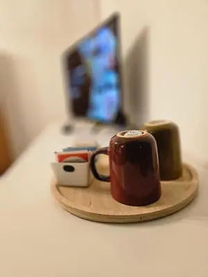 a wooden tray with a coffee cup and two green objects at Oasi Ballarak in Palermo