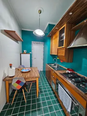 a kitchen with a table and a stove and a table at Oasi Ballarak in Palermo