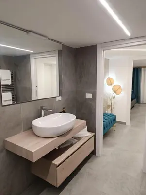 a bathroom with a white sink and a mirror at Home Luxury Felice in Palermo