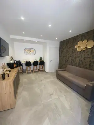 a living room with a couch and some chairs at Home Luxury Felice in Palermo